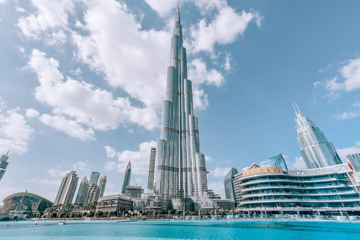 The Burj Khalifa towering over the Dubai Fountain lake on a clear day