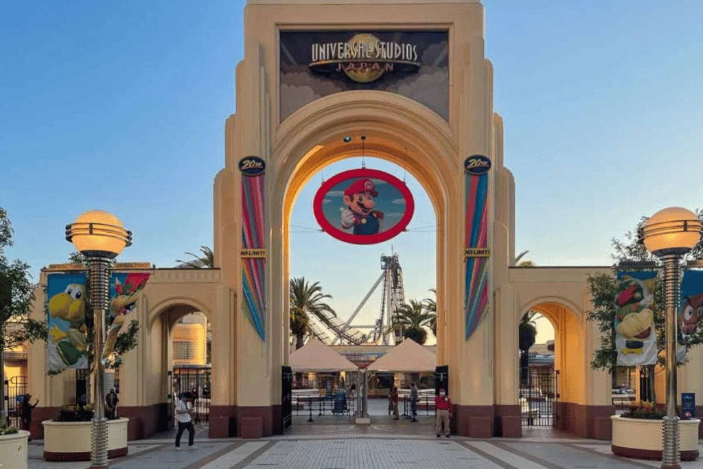 The Universal Studios Japan entrance arch with the Mario emblem and a near-empty plaza at opening