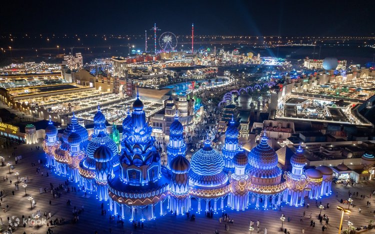 Aerial night view of Global Village's illuminated domes and fairground