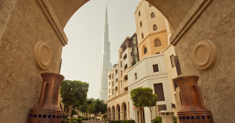 Burj Khalifa viewed through a traditional arched walkway in Downtown Dubai