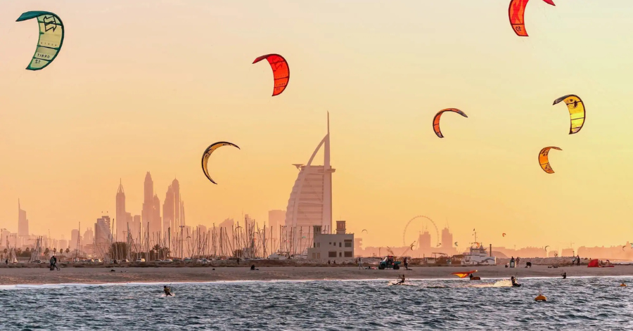 Kitesurfers on the water at Kite Beach with the Burj Al Arab on the skyline