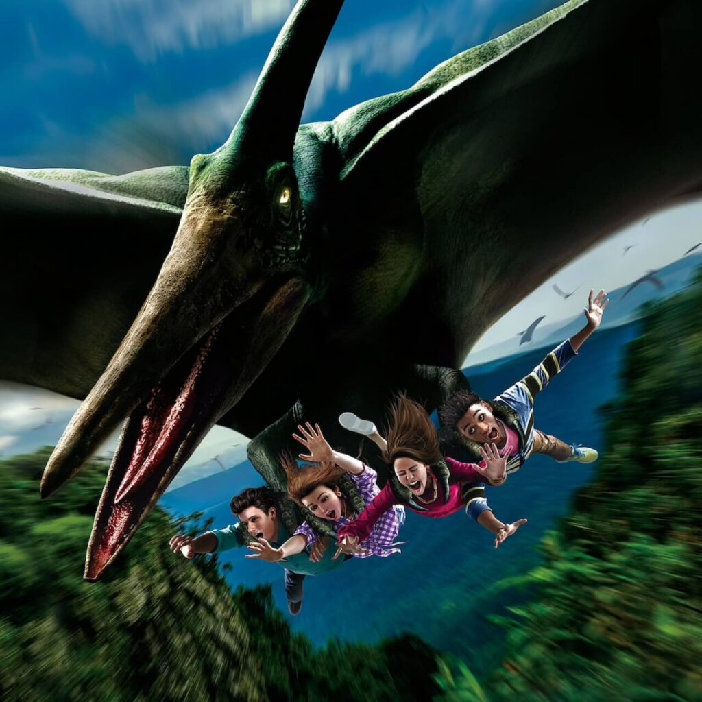 The Flying Dinosaur coaster carrying riders face-down beneath a pteranodon over the jungle