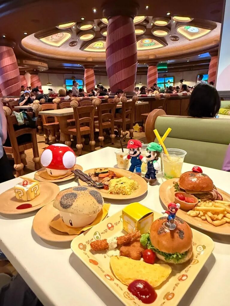 Themed dishes at a Super Nintendo World restaurant, with mushroom buns and Mario and Luigi figures