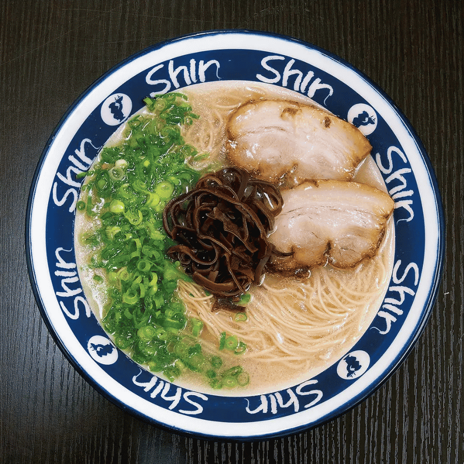 A bowl of Shin-Shin Hakata tonkotsu ramen with chashu pork, spring onions and kikurage