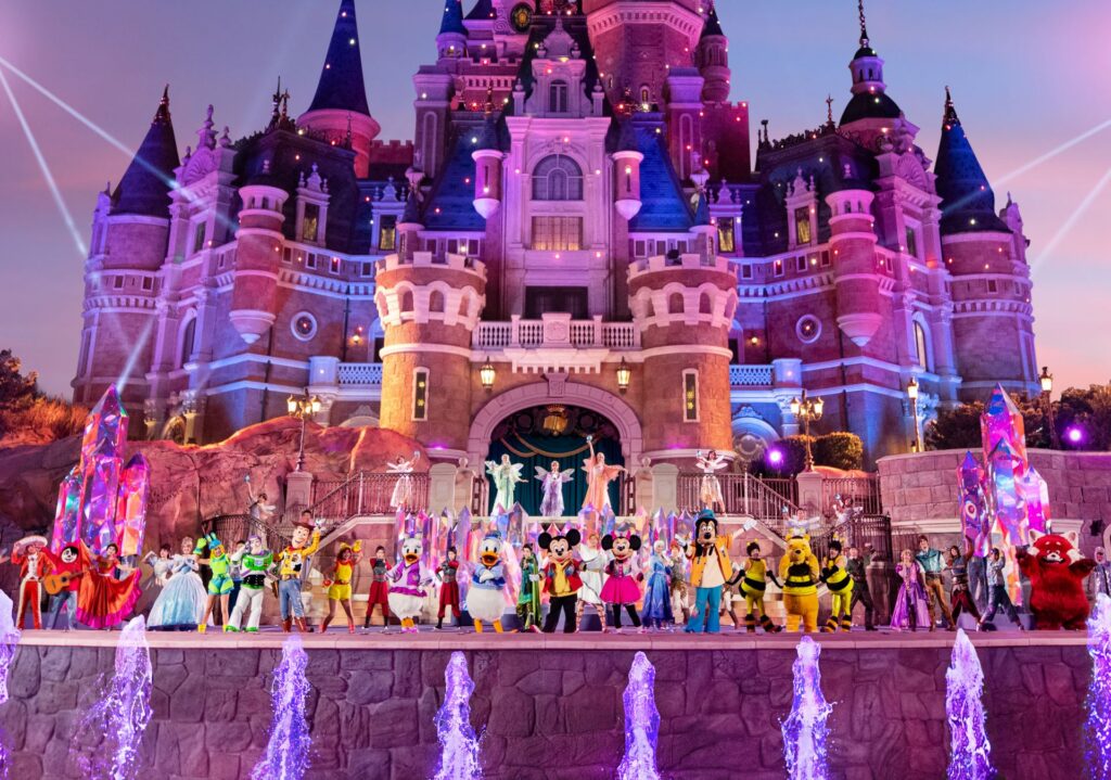 Disney characters and performers lined up in front of Shanghai Disneyland's lit-up castle for the 10th anniversary night show