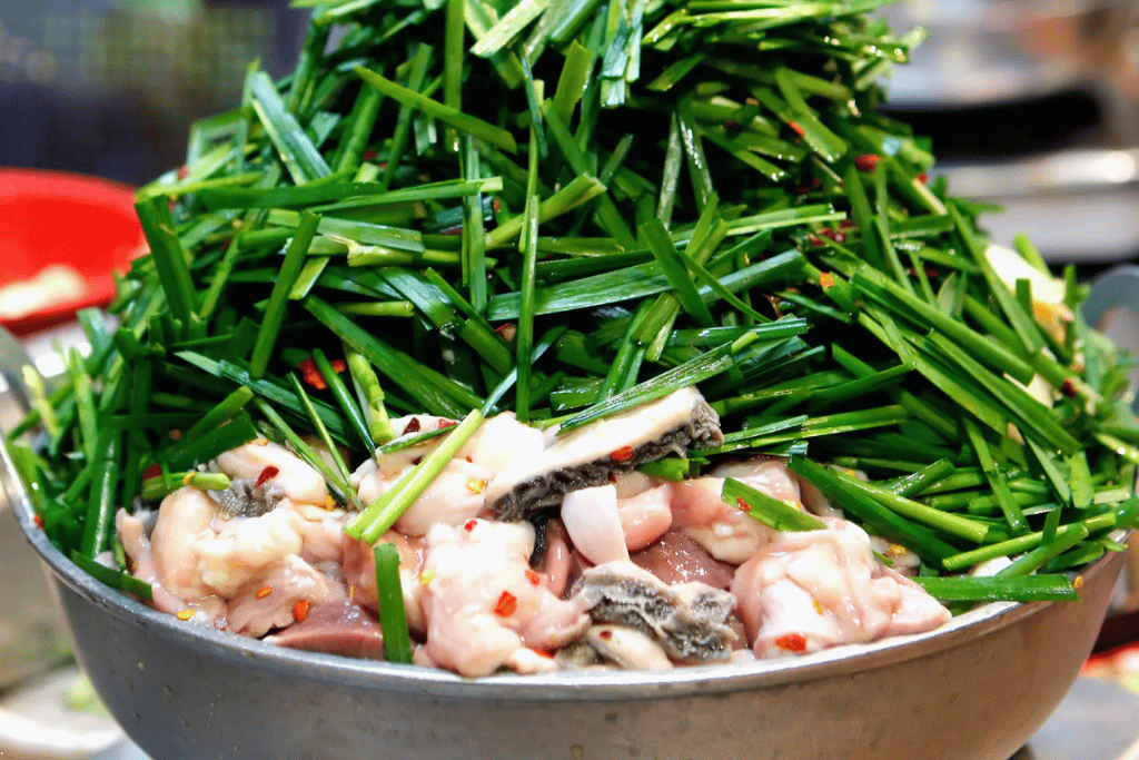 A motsunabe hotpot piled high with garlic chives over pork offal