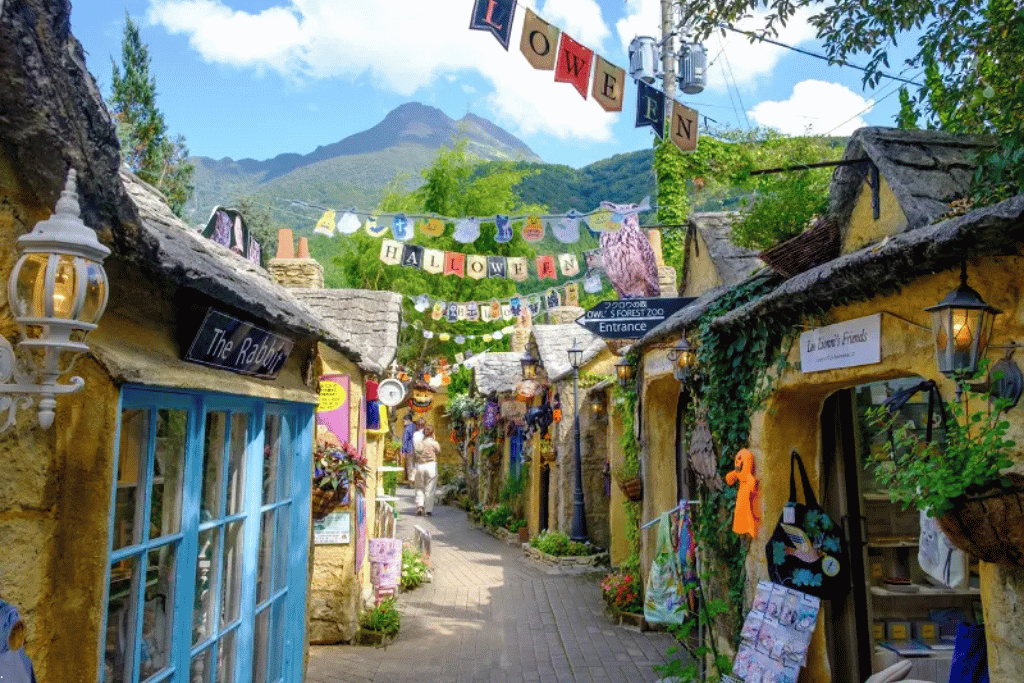 A European storybook-style lane at Yufuin's Floral Village with Mount Yufu rising behind