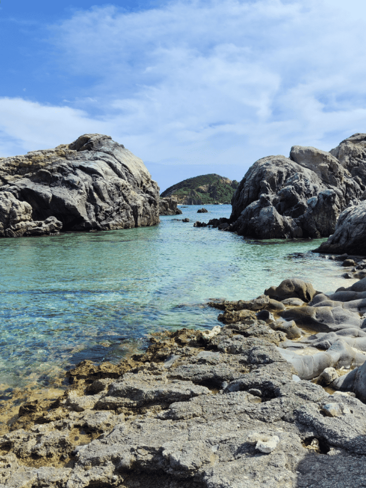 A rocky cove with clear turquoise water in the Kerama Islands
