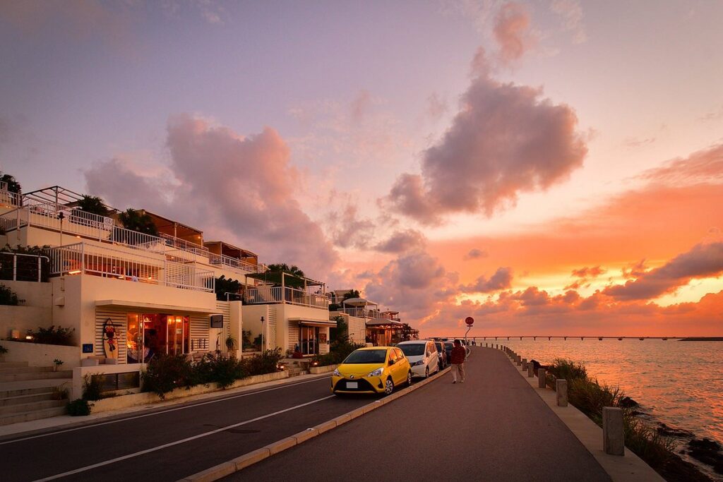 Umikaji Terrace's white buildings overlooking the sea at sunset