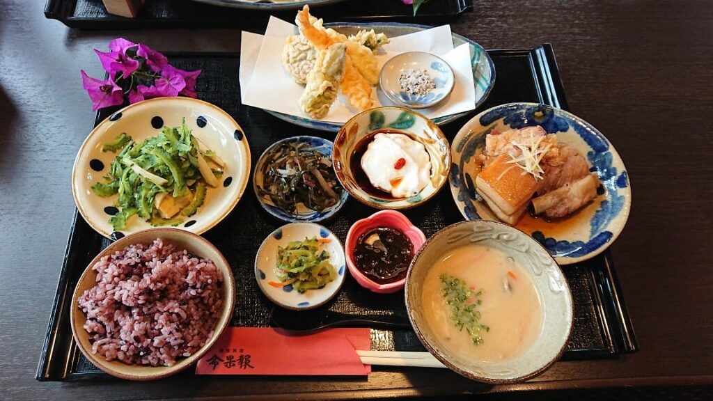 A traditional Okinawan set meal with rice, tempura and small side dishes at Nuchigafu