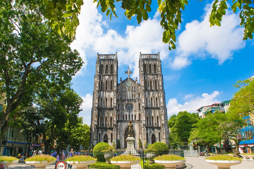 Weathered grey neo-Gothic towers of St Joseph's Cathedral in Hanoi