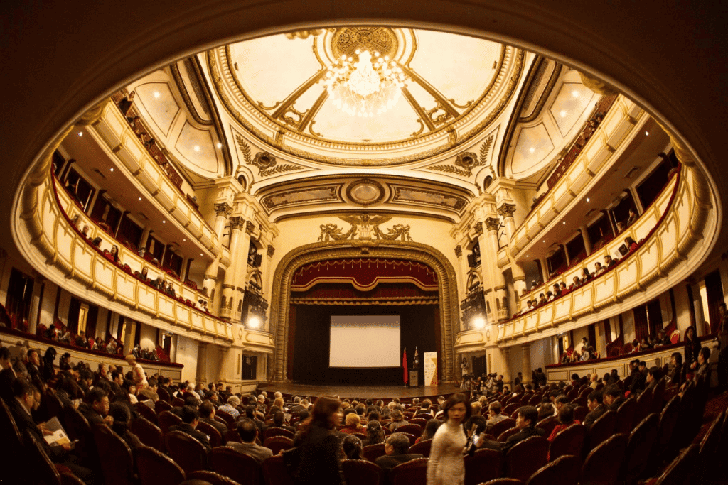 Gilded balconies and chandelier above a full audience inside the Hanoi Opera House