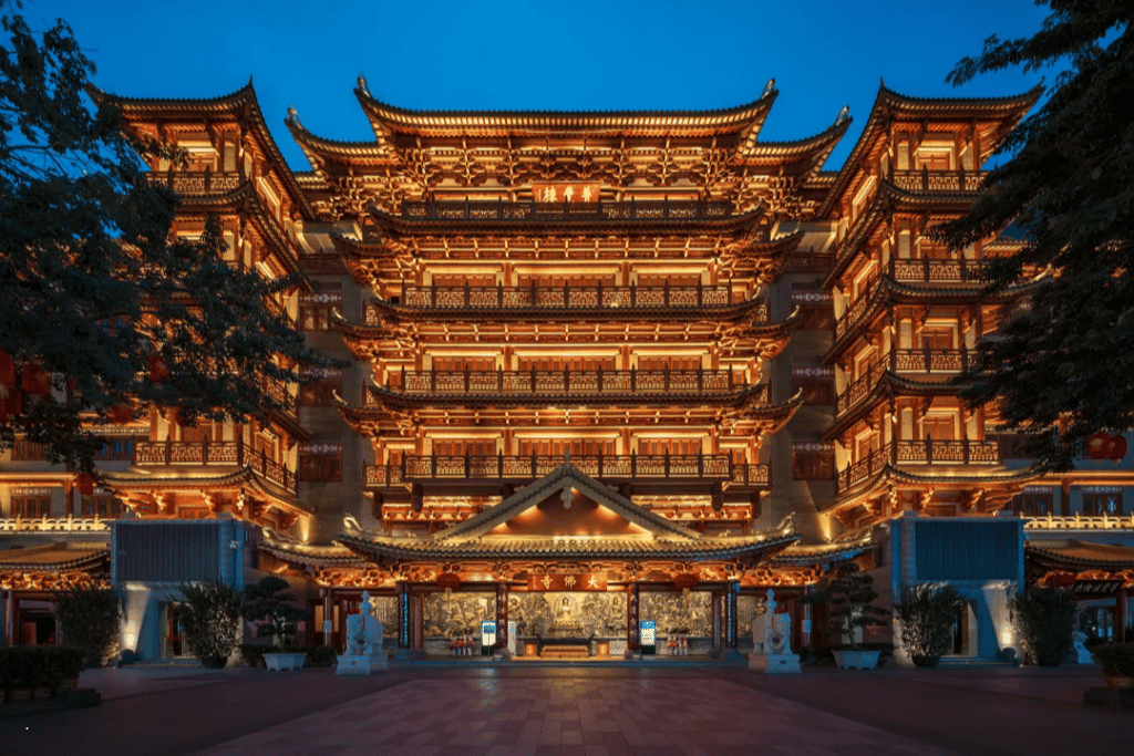 The multi-tiered Dafo Temple illuminated golden at night in central Guangzhou