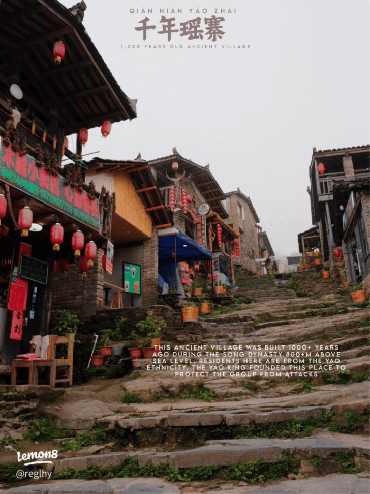 Stone-stepped lanes and red lanterns in the mountain Yao village of Millennium Yaozhai