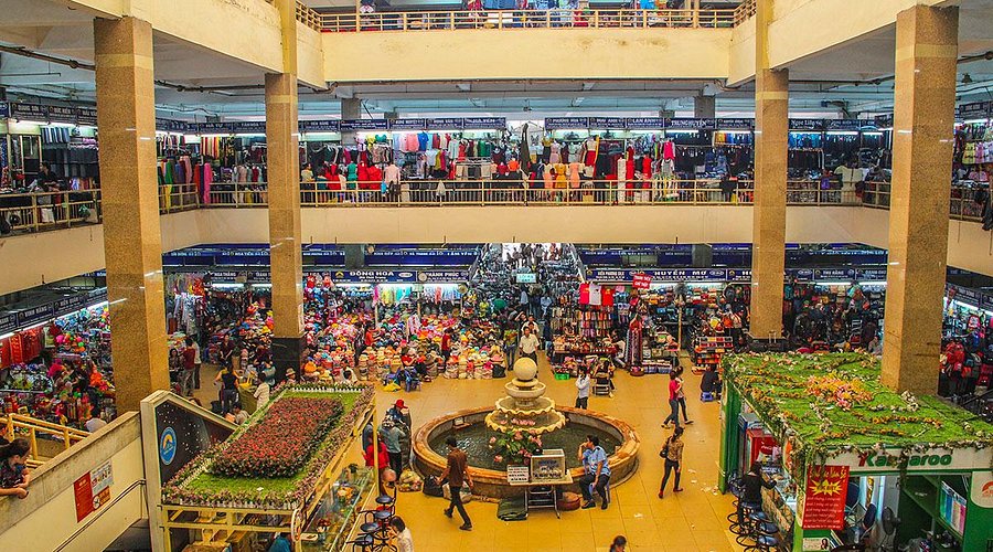 Multiple floors of stalls and a central fountain inside Hanoi's Dong Xuan Market