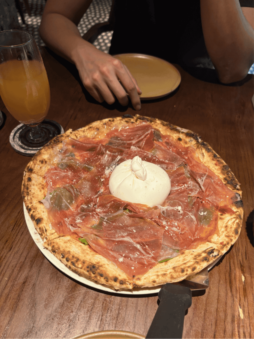 Wood-fired pizza topped with house-made cheese at Pizza 4P's