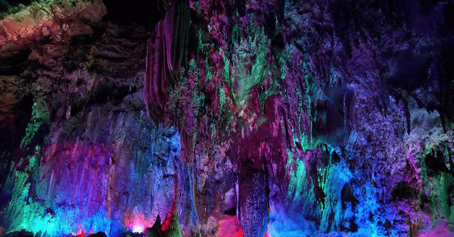 Colourfully lit stalactites and rock formations inside the Yingde karst caves near Guangzhou