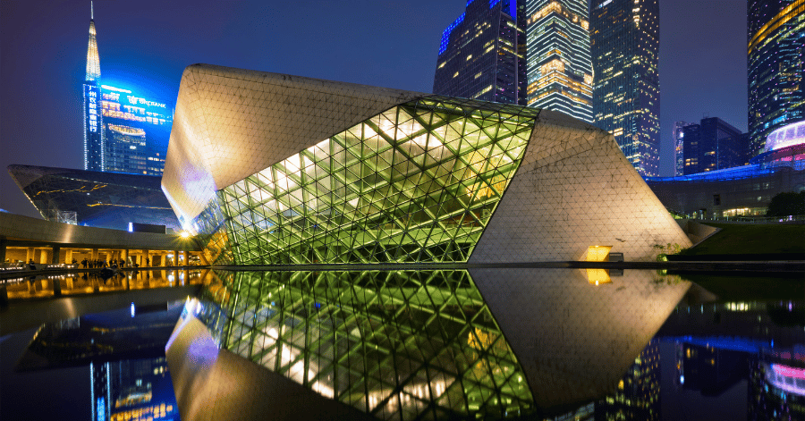 Guangzhou Opera House illuminated at night and reflected in the surrounding water