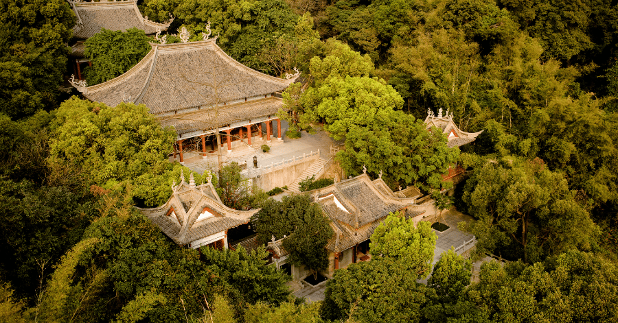 Traditional temple pavilions nestled among the green forested slopes of Baiyun Mountain