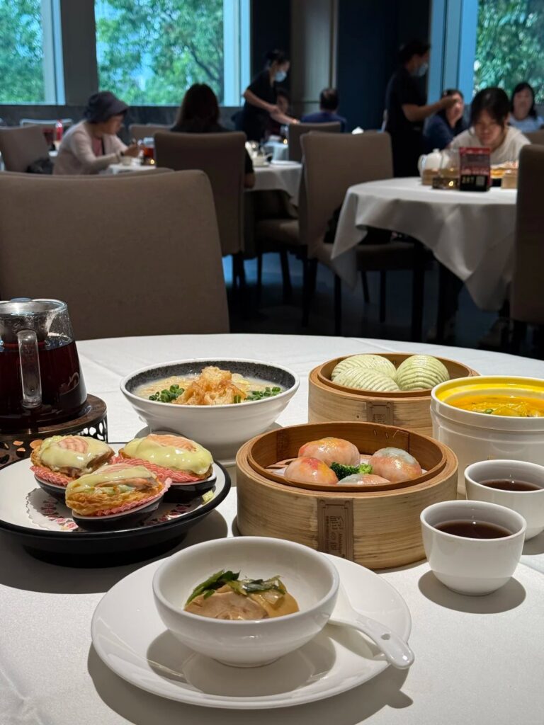 A spread of dim sum baskets and tea on a table at Yin Deng Shi Fu, Guangzhou