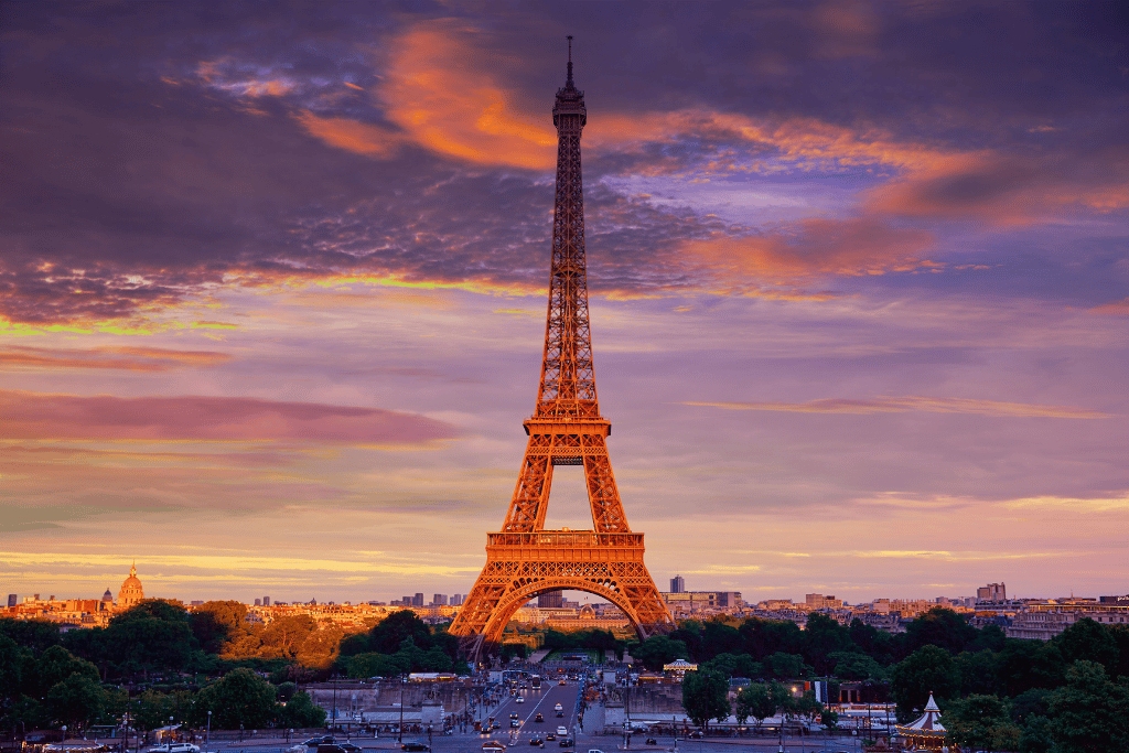 Looking up at the Eiffel Tower's underside and first level at sunset