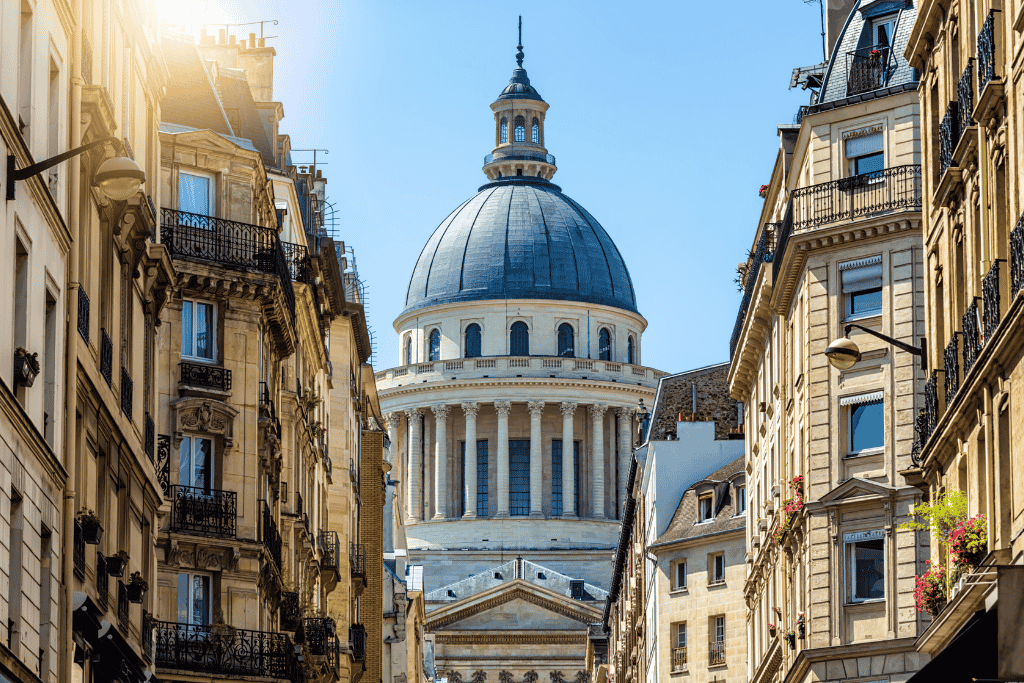 The Panthéon's dome rising above the narrow buildings of a Latin Quarter street