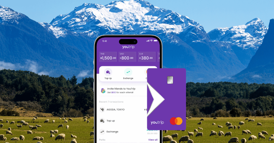 YouTrip purple Mastercard and app transaction screen set against snow-capped New Zealand mountains and pasture