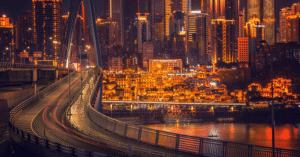 Chongqing's glowing night skyline with Hongyadong and a river bridge