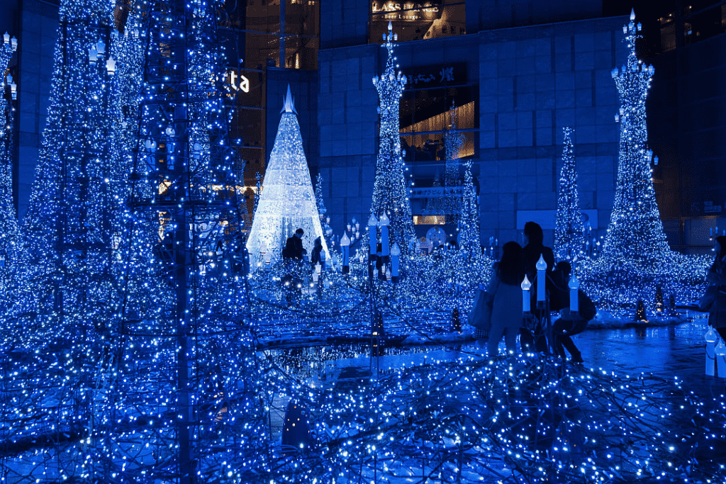 Blue winter illuminations lighting up a city plaza at night