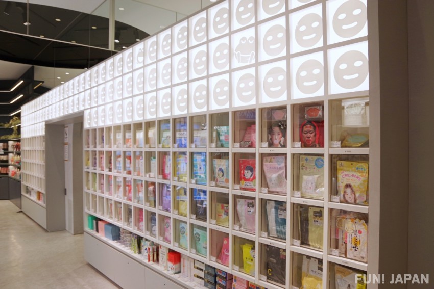 @cosme TOKYO's backlit sheet mask wall stacked with Japanese face masks