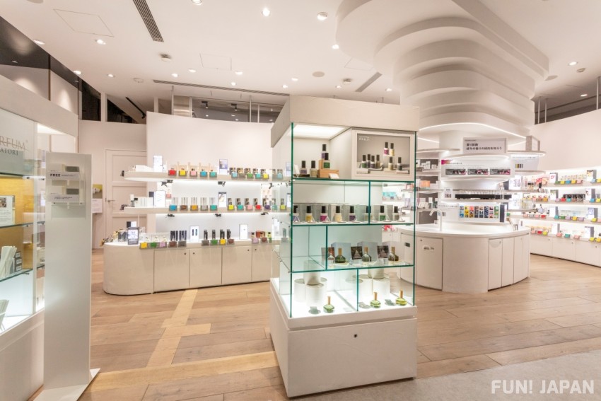 The fragrance floor at @cosme TOKYO with glass cases displaying perfume bottles