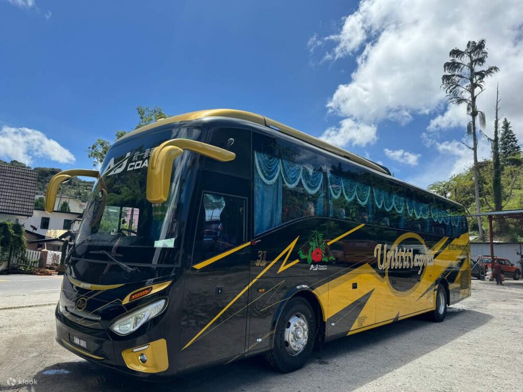 Black and gold Unititi Express coach parked in Cameron Highlands