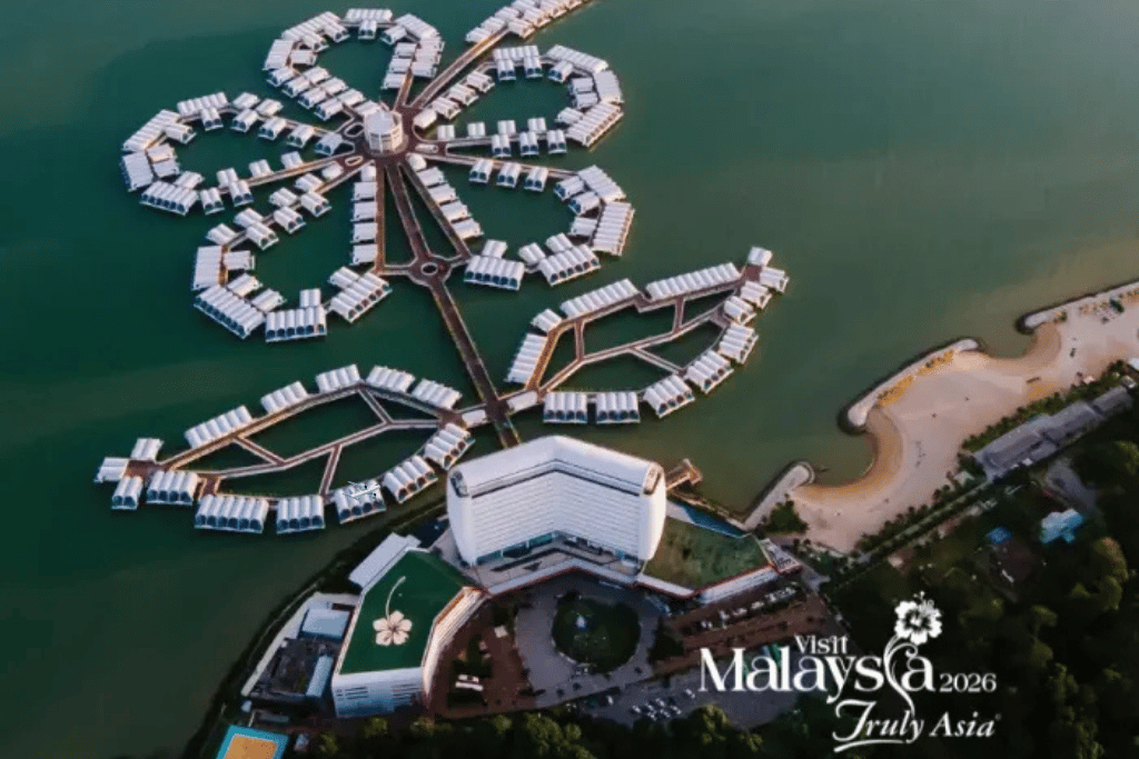 Aerial view of over-water villas arranged in a hibiscus-flower shape over the sea