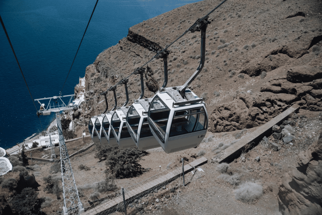 Cable car gondolas descending the Fira cliff to the Old Port, Santorini