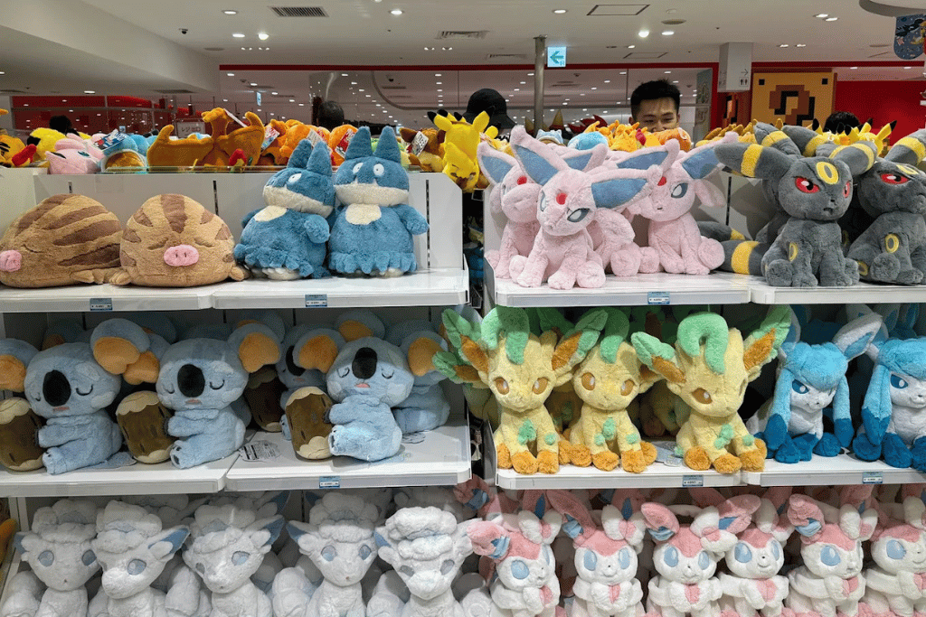 Shelves stacked with pastel Eevee-evolution Pokémon plush toys lining a store wall