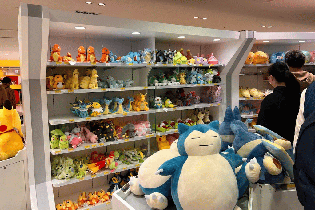 Store shelves of Pokémon plush with a large Snorlax plush in front as a shopper browses