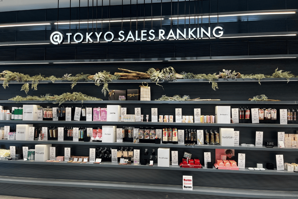 @cosme TOKYO sales ranking wall lined with top-ranked cosmetics under a lit sign