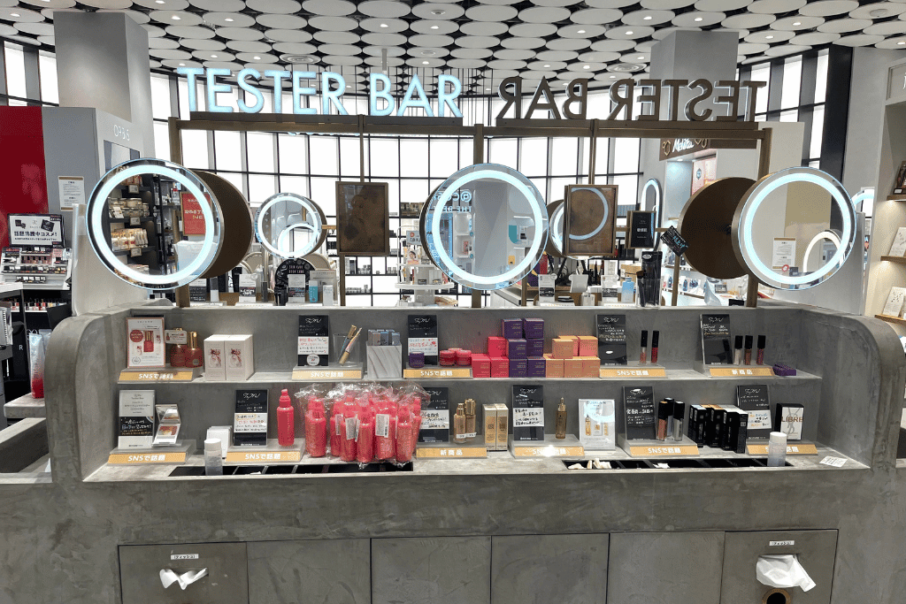 The Tester Bar at @cosme TOKYO with round lit mirrors and product testers laid out