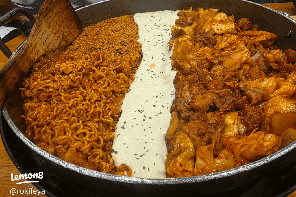 Sizzling pan of Korean dakgalbi with cheese, noodles and spicy chicken
