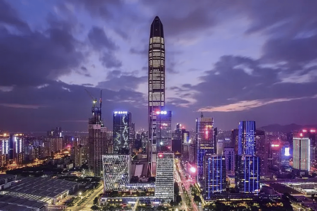 Ping An Finance Centre towering over the lit Shenzhen skyline at dusk