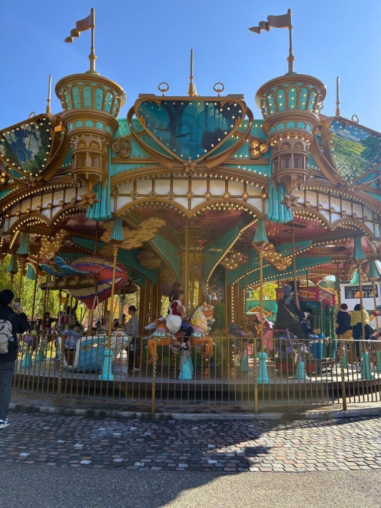 Ornate teal-and-gold carousel ride in the Valley of Witches at Ghibli Park