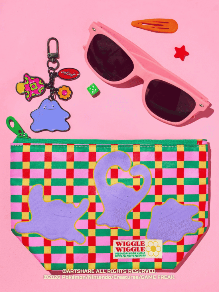 Flat-lay of pink sunglasses, hair clips, a checkered swan pouch and a purple Pokémon plush keychain