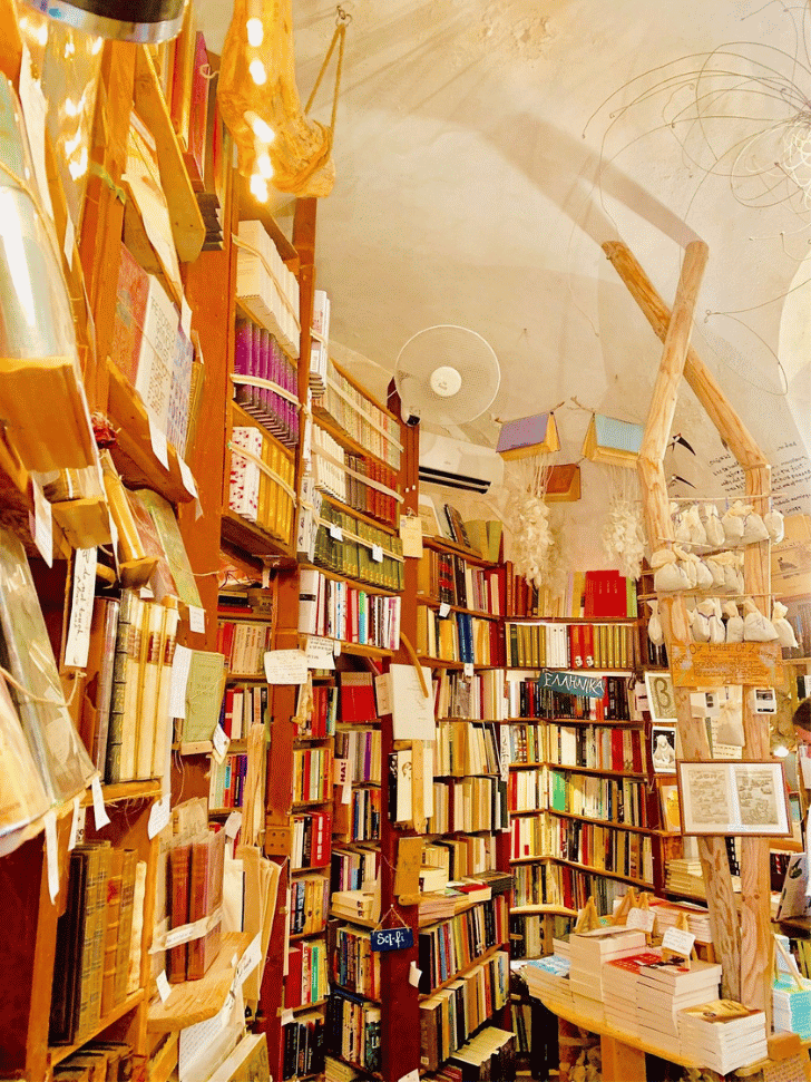 The book-lined cave interior of Atlantis Books bookshop in Oia, Santorini