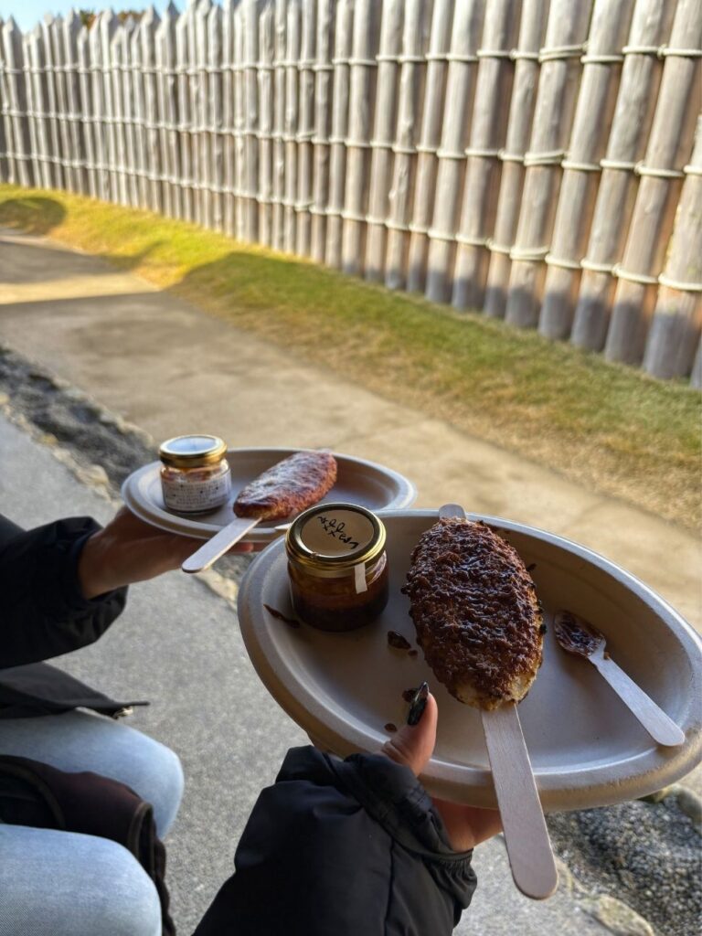 Plates of charcoal-grilled gohei-mochi rice cakes with sauce jars at Mononoke Village