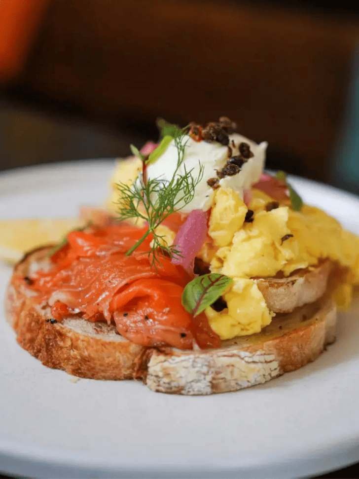 Smoked salmon and scrambled eggs on sourdough toast at a Bali café