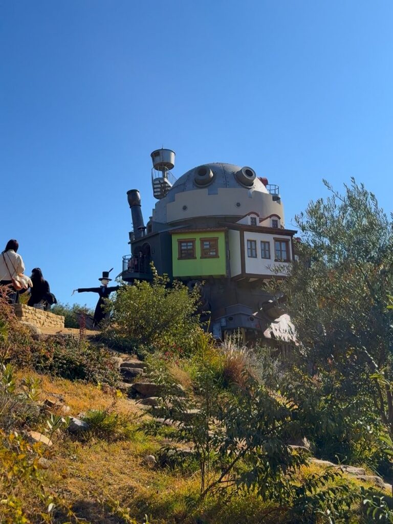Howl's Moving Castle with its domed top and chimneys on the hill in the Valley of Witches