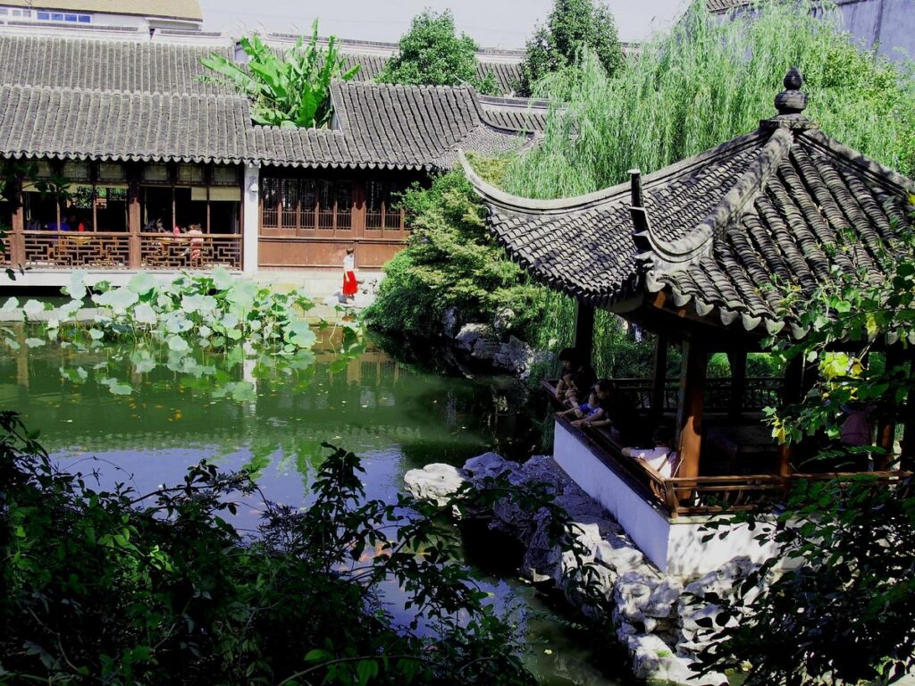 A tiled pavilion and lotus pond in a quiet classical Suzhou garden