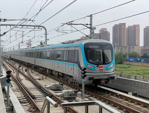 A Xi'an Metro train running on elevated tracks past city high-rises