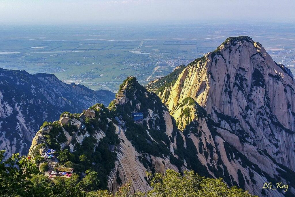 The steep granite peaks of Mount Huashan rising above the plains