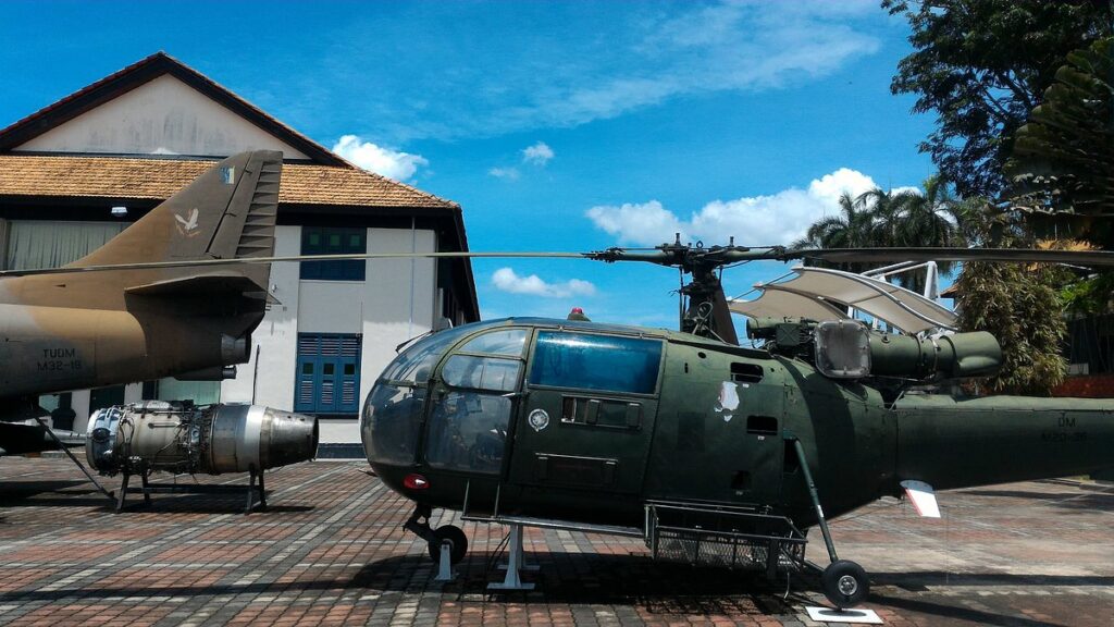 Military helicopter and fighter jet on outdoor display at the Port Dickson Army Museum